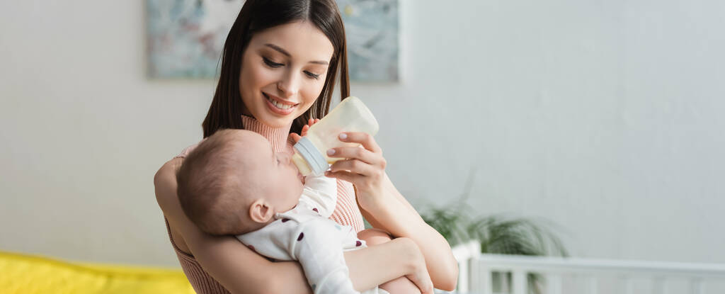stock-photo-happy-woman-baby-bottle-feeding-little-son-home-banner